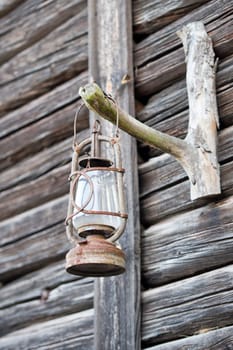 oil lamp on wooden cabin hut background