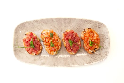 Bruschetta with salmon and tuna tartare on ciabatta toast. High quality photo