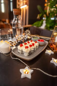 Sushi roll with cream cheese, sesame seeds and salmon caviar on a plate close-up. High quality photo