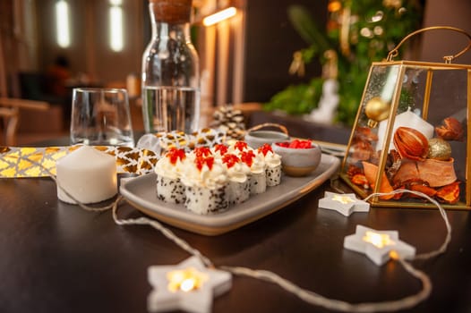 Sushi roll with cream cheese, sesame seeds and salmon caviar on a plate close-up. High quality photo