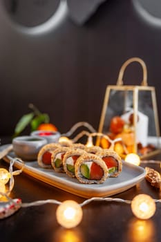 Classic sushi roll set in sesame with salmon, avocado and cream cheese. Japanese dish of fresh salmon and rice. High quality photo