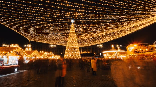 People in front of Christmas tree at Bucharest Christmas Market