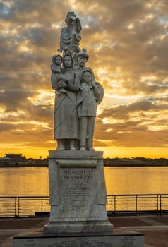 New Orleans, LA - 29 October 2023: Monument to the Immigrant sculpture by Franco Alessandrini on banks of Mississippi river in Louisiana