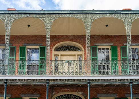 Facade of tradional New Orleans building in the French Quarter of the city with wrought iron balconies