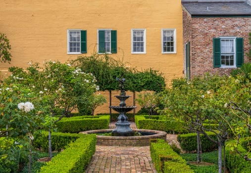 Small garden with brick paths and water fountain in French Quarter of New Orleans