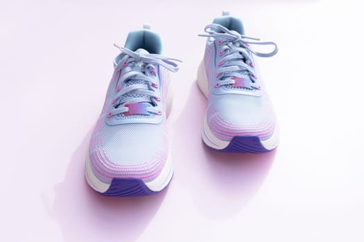 Purple Blue Female Sportive Running Shoes on Pink Background. Fashion, Training Footwear for Gym, Shoes For Woman. National Shoe The World Day. Horizontal Plane. High quality photo