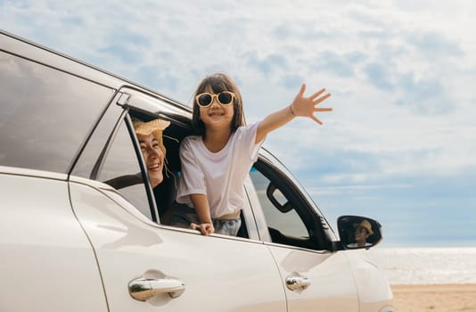 Happy family day. Asian Dad, mom and daughter little kid smiling sitting in compact car windows raise hand wave goodbye, Summer at beach, Car insurance, Family holiday vacation travel, road trip