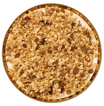 Oatmeal, raisins, cashews and almonds. Granola in round plate, top view