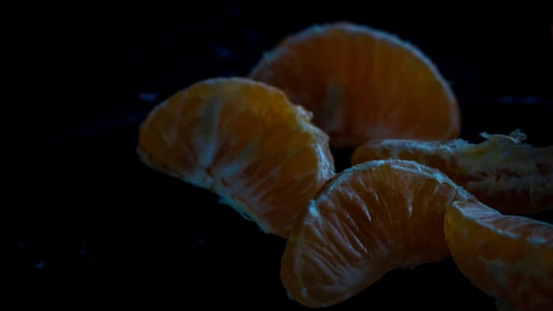 Sliced oranges on black background. Fresh fruit isolated on black