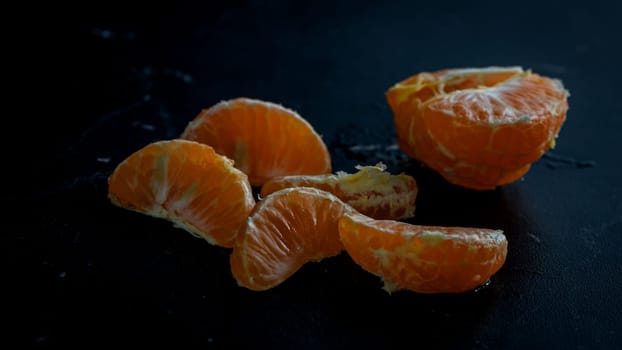 Sliced oranges on black background. Fresh fruit isolated on black