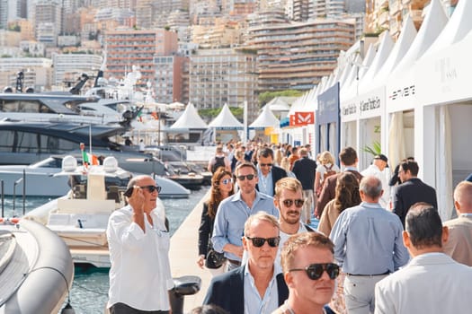 Monaco, Monte Carlo, 29 September 2022 - a lot of people, clients and yacht brokers look at the mega yachts presented, discuss the novelties of the boating industry at the famous motorboat exhibition. High quality photo