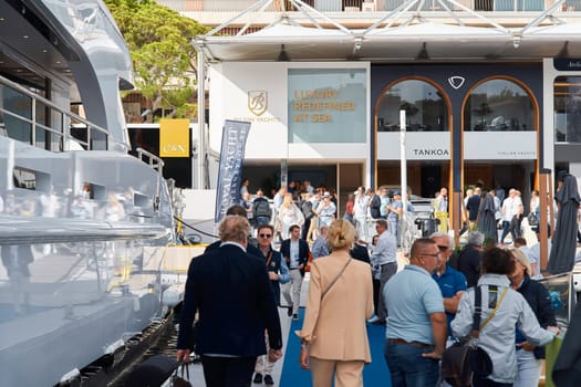 Monaco, Monte Carlo, 29 September 2022 - a lot of people, clients and yacht brokers look at the mega yachts presented, discuss the novelties of the boating industry at the famous motorboat exhibition. High quality photo