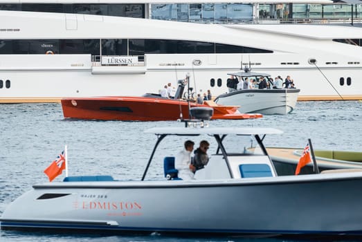 Monaco, Monte Carlo, 29 September 2022 - Water taxi by luxury motorboat on the famous yacht exhibition, a lot of most expensive luxury yachts, richest people, yacht brokers, boat traffic. High quality photo