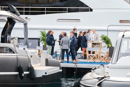 Monaco, Monte Carlo, 29 September 2022 - The famous motorboat exhibition, mega yacht show, clients and yacht brokers discuss the novelties of the boating industry, look at the mega yachts presented. High quality photo