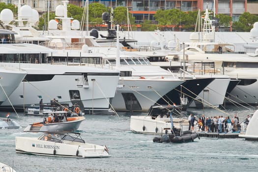 Monaco, Monte Carlo, 29 September 2022 - Water taxi by luxury motorboat on the famous yacht exhibition, a lot of most expensive luxury yachts, richest people, yacht brokers, boat traffic. High quality photo