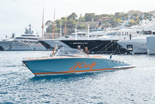 Monaco, Monte Carlo, 29 September 2022 - Water taxi by luxury motorboat on the famous yacht exhibition, a lot of most expensive luxury yachts, richest people, yacht brokers, boat traffic. High quality photo