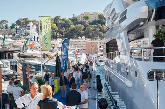 Monaco, Monte Carlo, 28 September 2022 - a lot of people, clients and yacht brokers look at the mega yachts presented, discuss the novelties of the boating industry at the famous motorboat exhibition. High quality photo