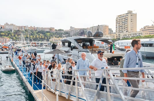 Monaco, Monte Carlo, 29 September 2022 - a lot of people, clients and yacht brokers look at the mega yachts presented, discuss the novelties of the boating industry at the famous motorboat exhibition. High quality photo