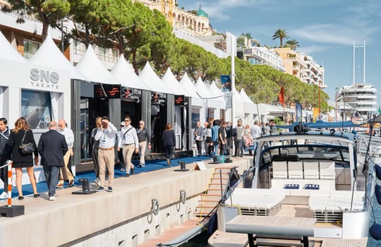 Monaco, Monte Carlo, 29 September 2022 - a lot of people, clients and yacht brokers look at the mega yachts presented, discuss the novelties of the boating industry at the famous motorboat exhibition. High quality photo