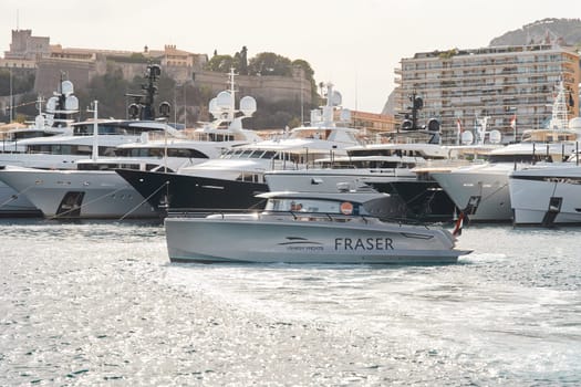 Monaco, Monte Carlo, 29 September 2022 - Water taxi by luxury motorboat on the famous yacht exhibition, a lot of most expensive luxury yachts, richest people, yacht brokers, boat traffic. High quality photo