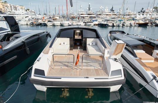 Monaco, Monte Carlo, 29 September 2022 - Close-up view of a relaxation area on the open teak deck of an expensive motorboat on famous boating exhibition at sunny day, yacht show, wealth life. High quality photo