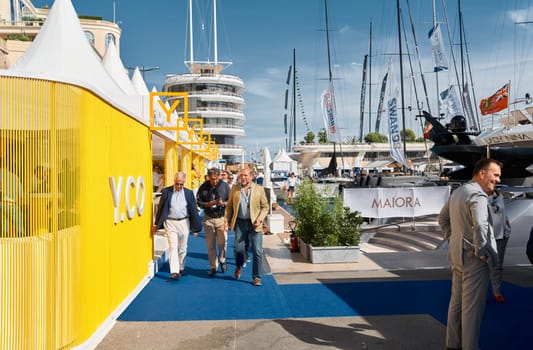 Monaco, Monte Carlo, 29 September 2022 - a lot of people, clients and yacht brokers look at the mega yachts presented, discuss the novelties of the boating industry at the famous motorboat exhibition. High quality photo