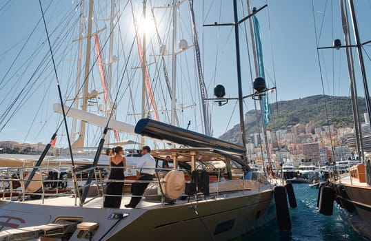 Monaco, Monte Carlo, 28 September 2022 - Invited wealthy clients inspect megayachts at the largest fair exhibition in the world yacht show MYS, port Hercules, yacht brokers, sunny weather. High quality photo