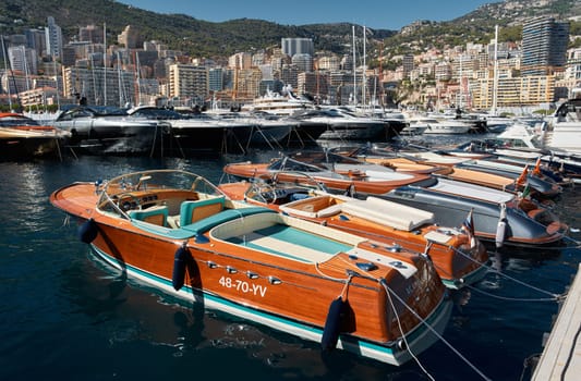 Monaco, Monte Carlo, 28 September 2022 - Riva boats in a row and a lot of luxury mega yachts at the famous motorboat exhibition in the principality, yacht brokers and clients. High quality photo