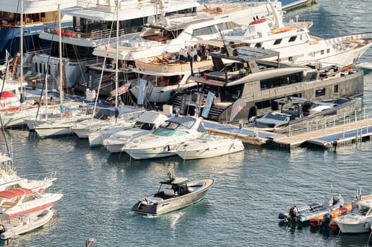 Monaco, Monte Carlo, 29 September 2022 - Water taxi by luxury motorboat on the famous yacht exhibition, a lot of most expensive luxury yachts, richest people, yacht brokers, boat traffic. High quality photo