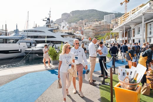 Monaco, Monte Carlo, 29 September 2022 - a lot of people, clients and yacht brokers look at the mega yachts presented, discuss the novelties of the boating industry at the famous motorboat exhibition. High quality photo