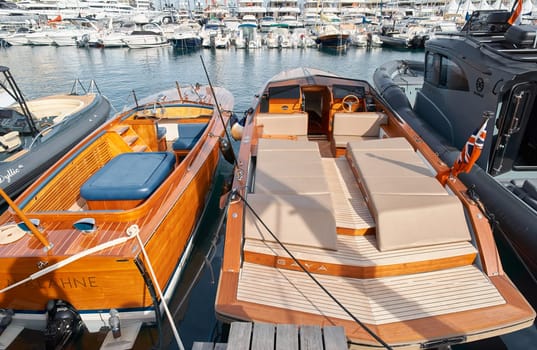 Monaco, Monte Carlo, 29 September 2022 - Close-up view of a relaxation area on the open teak deck of an expensive motorboat on famous boating exhibition at sunny day, yacht show, wealth life. High quality photo