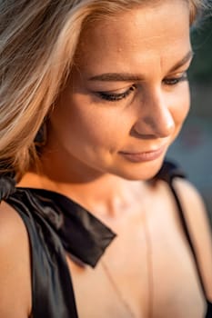 Blonde long hair, nature summer happy adult girl with long blond hair developing in the wind in nature. Dressed in a black top, white skirt