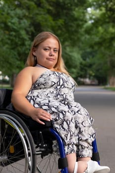 International Wheelchair Day , March 1st Smiling. Pretty Young Woman With Short Stature Sitting In Wheel Chair In Outdoor. Park On Background. Person With Special Needs Enjoys Social Life. Vertical