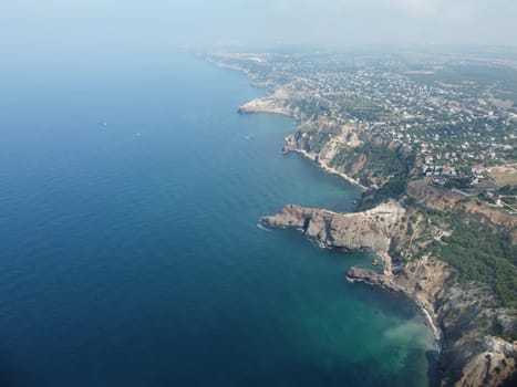 Aerial panoramic view of beautiful sunset above sea. Beautiful seascape. Sun glare, small waves on the water surface. Evening. Horizon. Nobody. No people. Copy space. Never-ending beauty of nature