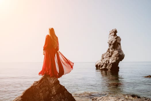 Woman travel sea. Happy tourist taking picture outdoors for memories. Woman traveler looks at the edge of the cliff on the sea bay of mountains, sharing travel adventure journey.