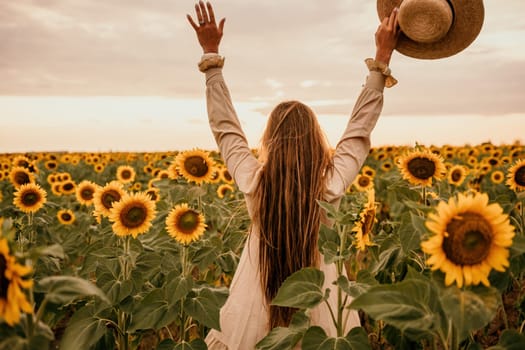 Woman in the sunflowers field. Summer time. Young beautiful woman standing in sunflower field.