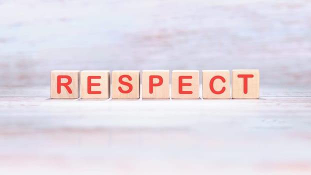 respect word made of wooden cubes on a light background