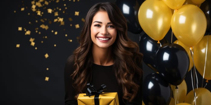 People, joy, fun and happiness concept. happy mixed race birthday woman holding with gift box, gold and black balloons in the background. AI Generated