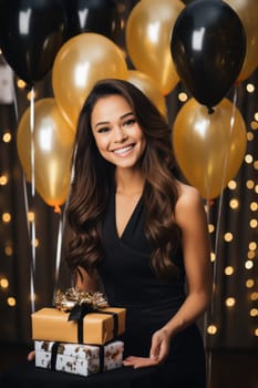 People, joy, fun and happiness concept. happy mixed race birthday woman holding with gift box, gold and black balloons in the background. AI Generated