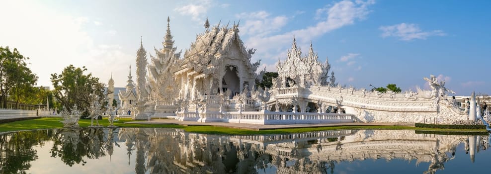 White Temple Chiang Rai Thailand, Wat Rong Khun Northern Thailand with reflection in the pond, panoramic view