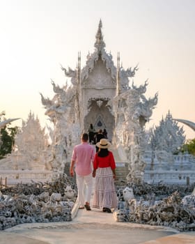 White Temple Chiang Rai Thailand,a diverse couple of men and woman visit Wat Rong Khun temple, Northern Thailand.