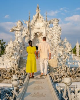 White Temple Chiang Rai Thailand, a diverse couple of men and women visit Wat Rong Khun temple or the white temple in Northern Thailand.