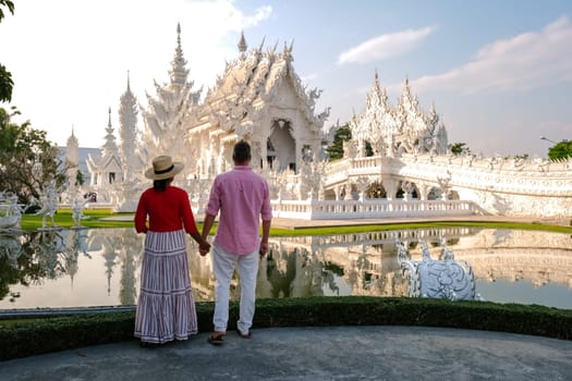 White Temple Chiang Rai Thailand, a diverse couple of men and women visit Wat Rong Khun temple or the white temple in Northern Thailand.