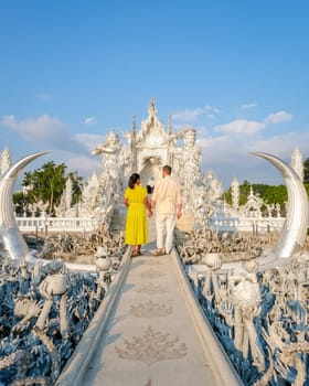 White Temple Chiang Rai Thailand,a couple of men and women visit Wat Rong Khun temple, Northern Thailand.