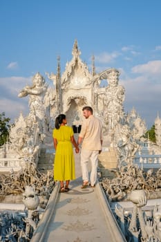 White Temple Chiang Rai Thailand,a couple of men and women visit Wat Rong Khun temple, Northern Thailand.