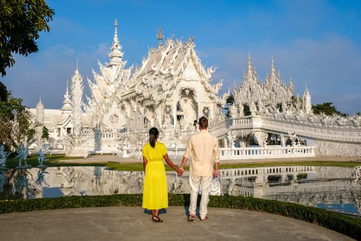White Temple Chiang Rai Thailand, a diverse couple of European men and Asian women visit Wat Rong Khun temple, Northern Thailand.