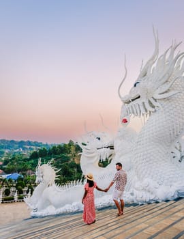 A couple visits Wat Huay Pla Kang Chiang Rai Thailand, Wat Hua Pla Kang is one of the most impressive temples in Chiang Rai. White big Budha in Chiang Rai