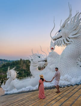 A couple visits Wat Huay Pla Kang Chiang Rai Thailand, Wat Hua Pla Kang is one of the most impressive temples in Chiang Rai Thailand. White big Budha in Chiang Rai