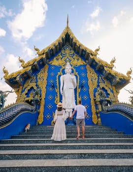 Rong Sua Ten Temple or Blue Temple Chiang Rai Province Thailand , a diverse couple visit the blue temple in Chiang Rai, men and woman travel around Thailand