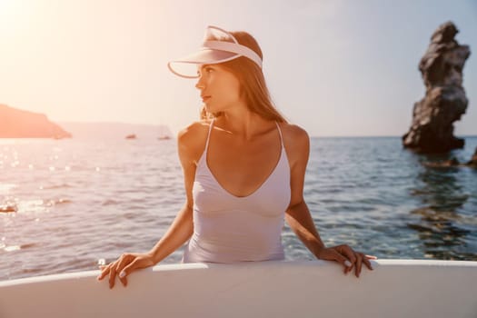 Close up shot of happy young caucasian woman looking at camera and smiling. Cute woman portrait in bikini posing on a volcanic rock high above the sea